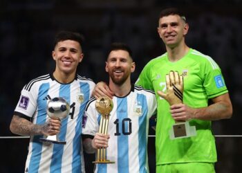 Le jeune joueur du tournoi Enzo Fernandez, le vainqueur du Ballon d'or Lionel Messi et le vainqueur du Gant d'or Emiliano Martinez posent avec leurs trophées le 18 décembre 2022